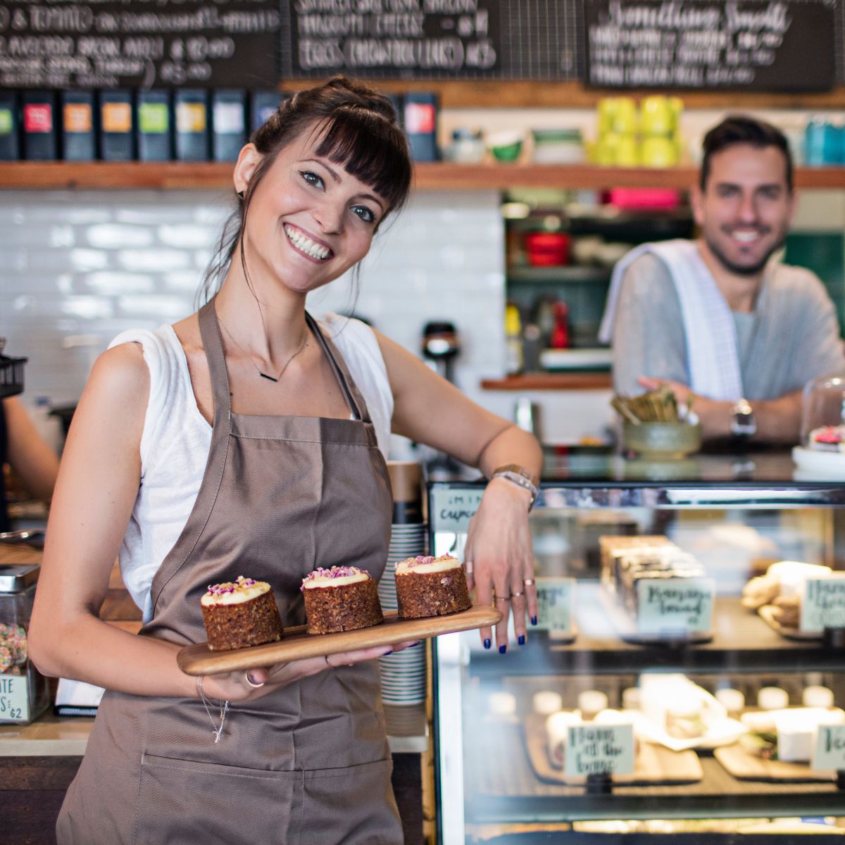 man and woman working at a cafe